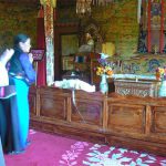 Tibet: Lhasa - Summer Palace Buddhist devotees offer prayers in throne