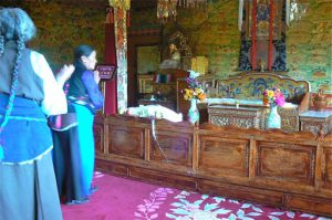 Tibet: Lhasa - Summer Palace Buddhist devotees offer prayers in throne