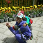 Tibet: Lhasa - Summer Palace Visitor with her child.