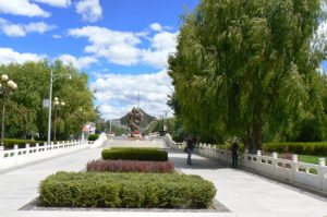 Tibet: Lhasa - Summer Palace entry walk with sculpture.