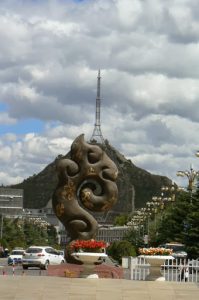 Tibet: Lhasa - Summer Palace sculpture outside front gate  with transmission