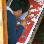 Tibet: Lhasa Thanka painting requires a very steady hand using tiny