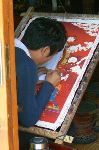 Tibet: Lhasa Thanka painting requires a very steady hand using tiny