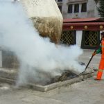 Tibet: Lhasa  Worker stirring ashes of the smoking vat at Jokhang