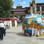 Tibet: Lhasa  Jokhang Temple. Prayer flags cover the base of a