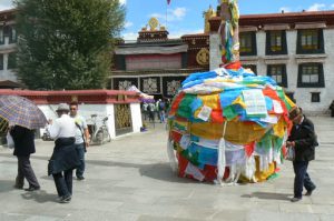 Tibet: Lhasa  Jokhang Temple. Prayer flags cover the base of a