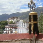 Tibet: Lhasa Distant view of Potala Palace from Jokhang Temple. Sacred juniper