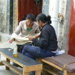Tibet: Lhasa Two women winding threads of wool.