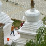 Tibet: Lhasa - Pabonka Monastery.  Women throw the milky paint