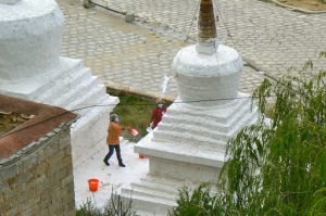 Tibet: Lhasa - Pabonka Monastery.  Women throw the milky paint