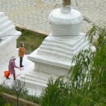 Tibet: Lhasa - Pabonka Monastery.  Women throw the milky paint