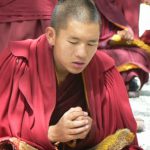 Tibet: Lhasa - Sera Monastery. A young monk contemplating his reply
