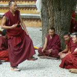 Tibet: Lhasa - Sera Monastery. A teacher uses his feet to