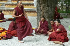 Tibet: Lhasa - Sera Monastery. A teacher uses his feet to