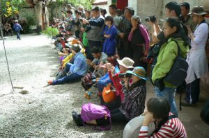 Tibet: Lhasa - Sera Monastery. Spectators seem enthralled at the sound