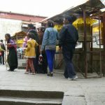 Tibet: Lhasa - Sera Monastery. Visitors spinning prayer wheels before  they