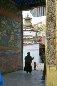 Tibet - a monk walks through Palcho Monastery in Gyantse.