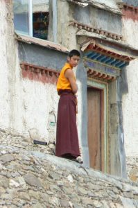 Tibet - a young monk ponders in Palcho Monastery.