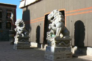 Tibet - mythological protective lions at entry to Sakya