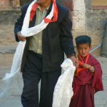 Tibet - a father leads his child monk to Sakya