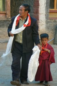 Tibet - a father leads his child monk to Sakya