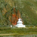 Tibet - a striking white stupa against a mineral rock