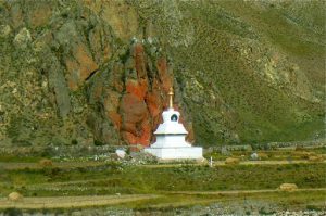 Tibet - a striking white stupa against a mineral rock