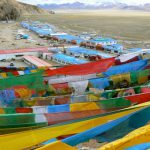 Tibet - prayer flags fly above Namtso Lake village.