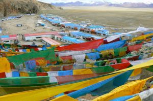 Tibet - prayer flags fly above Namtso Lake village.