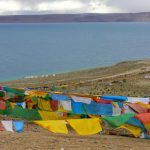 Tibet - prayer flags fly above Namtso Lake.