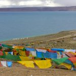 Tibet - prayer flags fly above Namtso Lake.