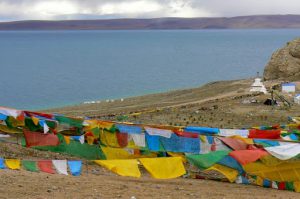 Tibet - prayer flags fly above Namtso Lake.