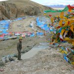 Tibet - prayer flags fly above Namtso village.