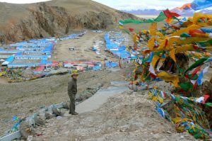 Tibet - prayer flags fly above Namtso village.