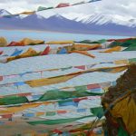 Tibet - prayer flags fly above Namtso Lake.