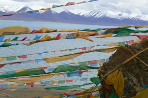 Tibet - prayer flags fly above Namtso Lake.