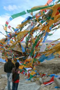 Tibet - prayer flags fly above Namtso Lake.