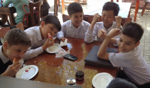 Uzbekistan: Tashkent School kids eating lunch at a fast food eatery dressed