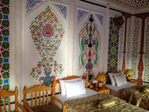 Uzbekistan: Bukhara boutique Hotel Sasha & Son interior decorated walls.