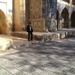 Uzbekistan: Bukhara young man exiting the Nadir Divanbegi Medressa .