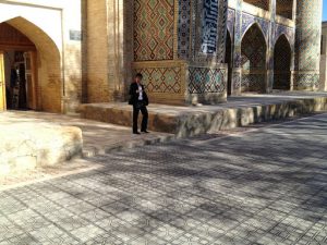 Uzbekistan: Bukhara young man exiting the Nadir Divanbegi Medressa .