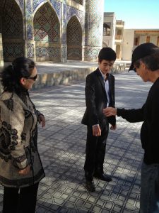 Uzbekistan: Bukhara young man showing his shiny suit (polished cotton?)