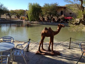 Uzbekistan: Bukhara the central park pond with metal camel statue and