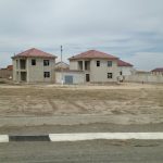 Uzbekistan: Khiva On the road from Bukhara to Khiva; more government-built houses.