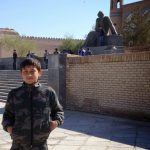 Uzbekistan: Khiva Young boy in front of a statue of the