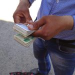 Uzbekistan: Khiva A black-market money changer counts his bills in an