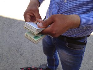 Uzbekistan: Khiva A black-market money changer counts his bills in an