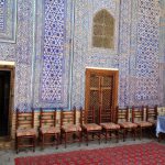 Uzbekistan: Khiva Glazed tile wall and woven carpet of an aiwan