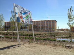 Uzbekistan: Nukus A new school. The sign shows president Karimov with