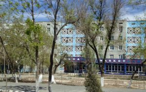 Uzbekistan: Nukus A commercial and residential street with 5-story buildings.